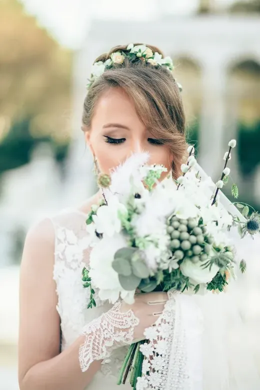 Bride with a greenery crown and white bouquet, soft glam makeup