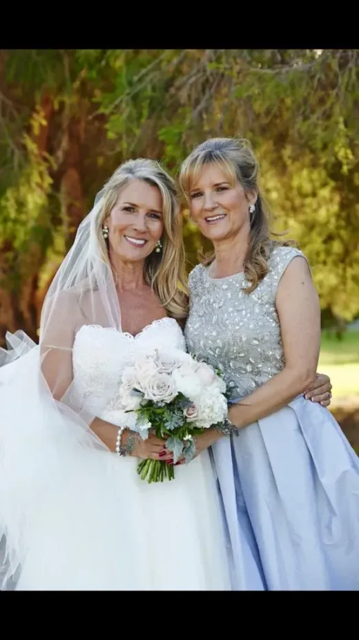 Bride with a bridesmaid outdoors