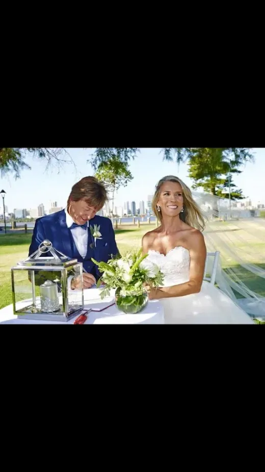 Newlyweds seated together outdoors