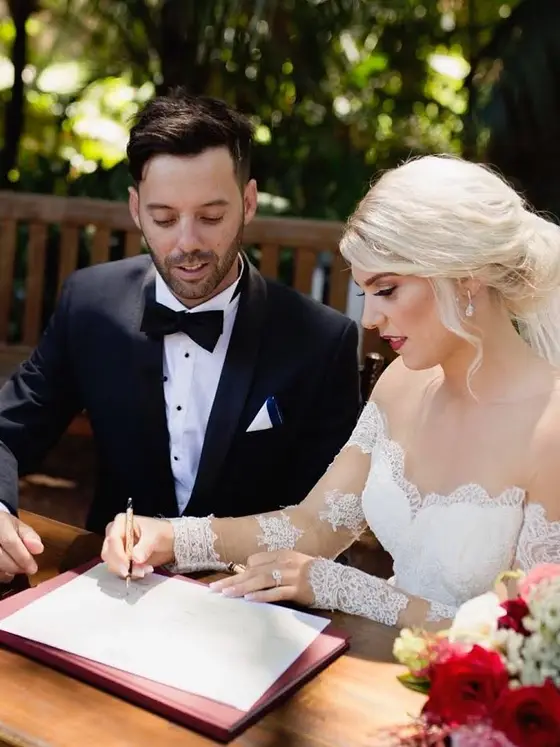 Bride and groom signing the register, soft bridal glam